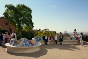 The main terrace at Park Güell with its coloured mosaic bench and Barcelona behind