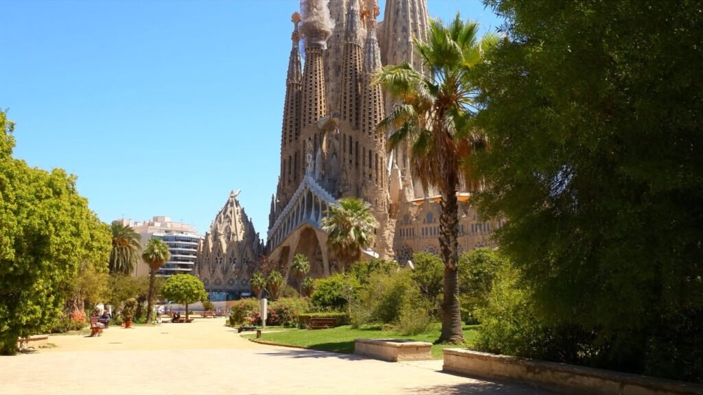 Sagrada Família in Barcelona on a sunny morning, palm trees in the foreground